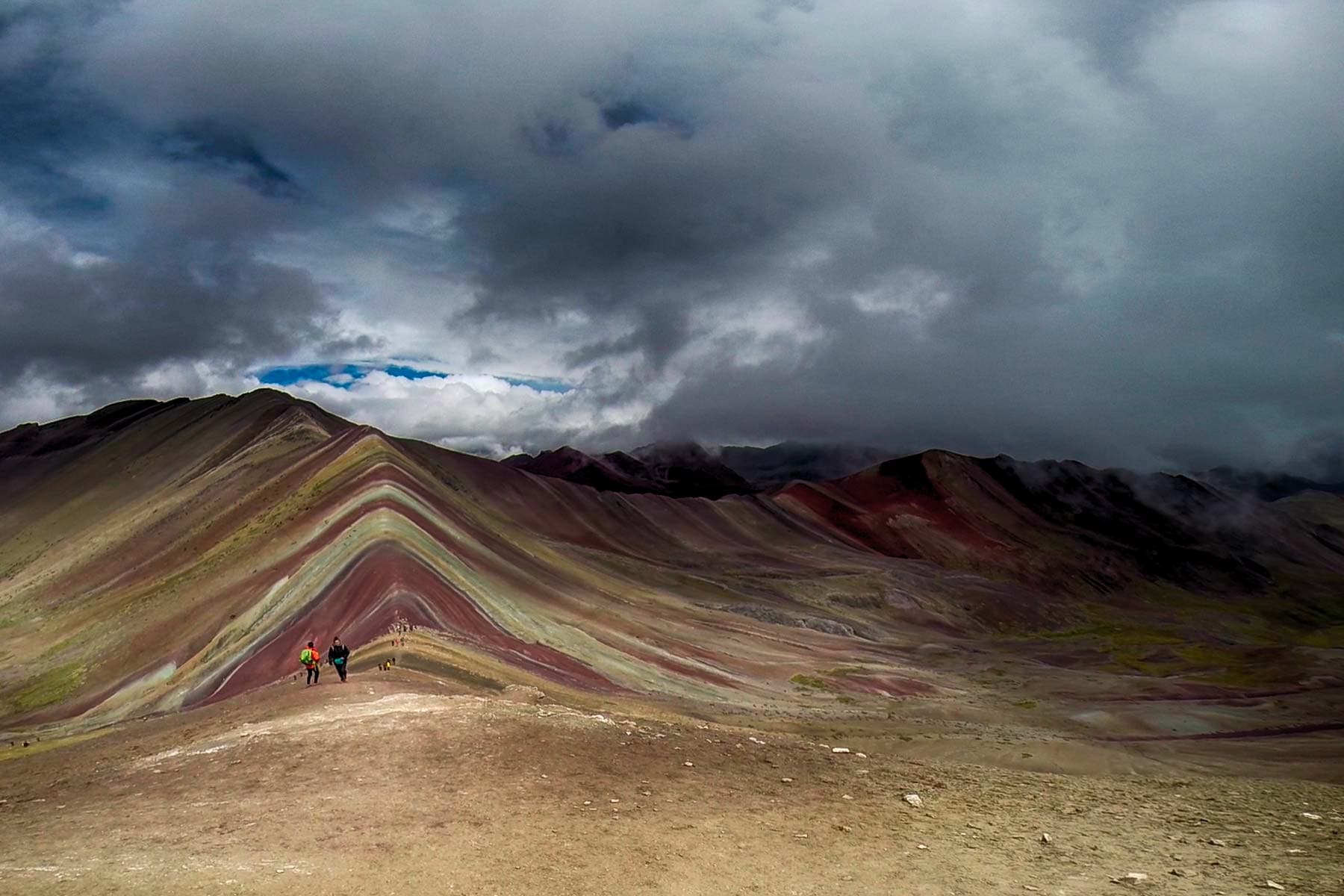 Vinicunca vs Palcoyo Mountain Comparison Guide Steep colorful mineral ridges of Vinicunca Rainbow Mountain at 5,036 meters (16,522 feet) in Cusco, Peru