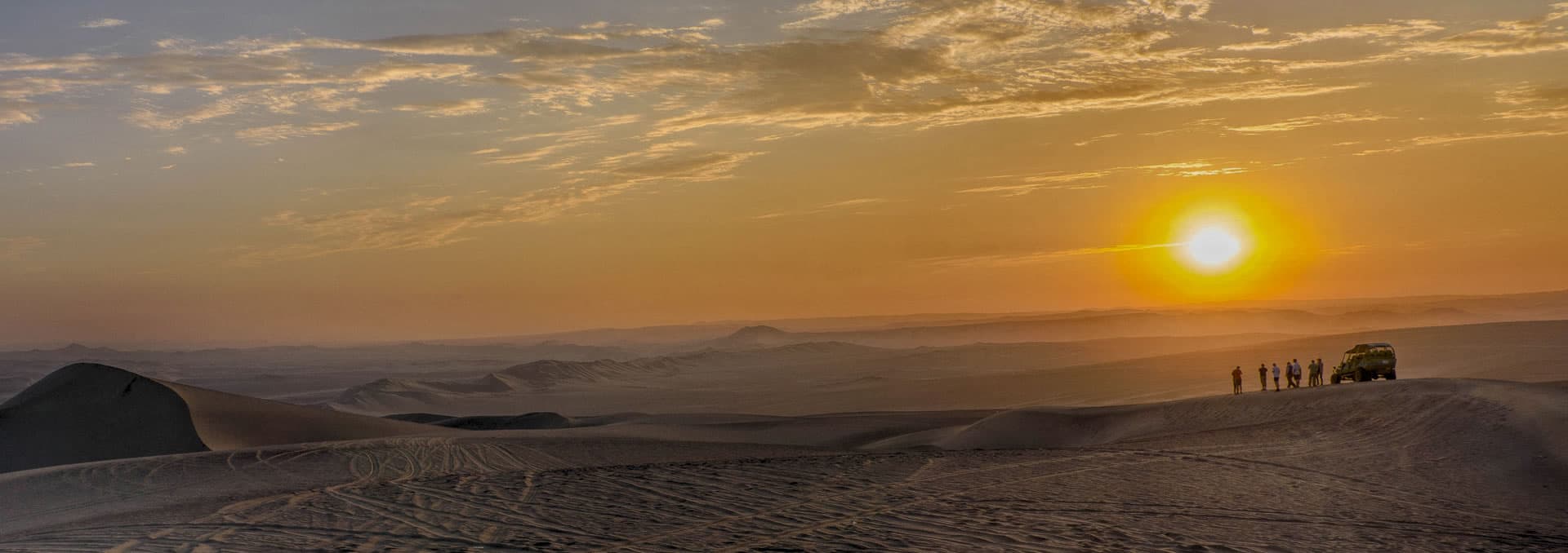 Natural desert oasis lagoon of Huacachina surrounded by massive sand dunes in Ica, Peru