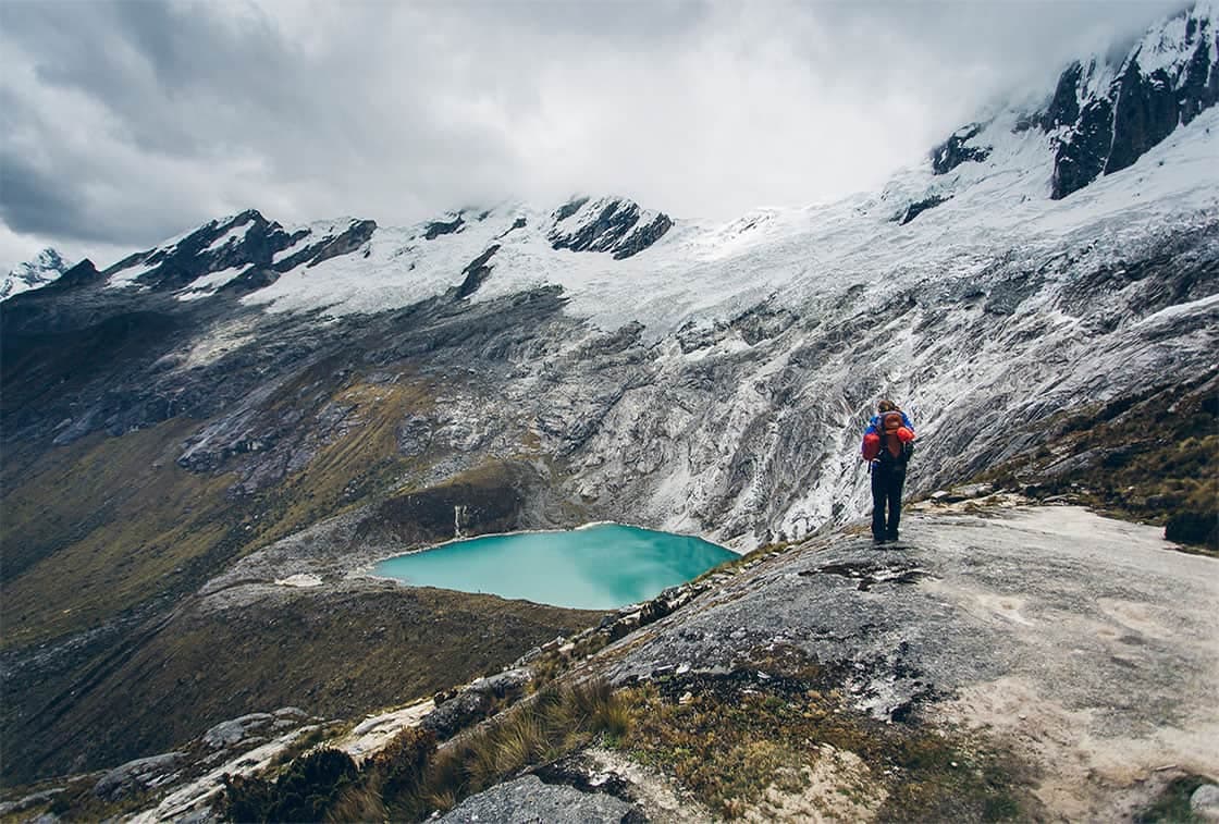 Glacial tarn and high snow-capped summits along the Santa Cruz trail