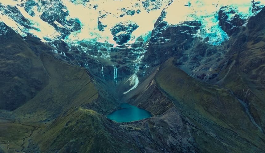 Turquoise glacial waters of Lake Humantay at 4,200m (13,779 ft) beneath Mount Salkantay, Mollepata, Cusco